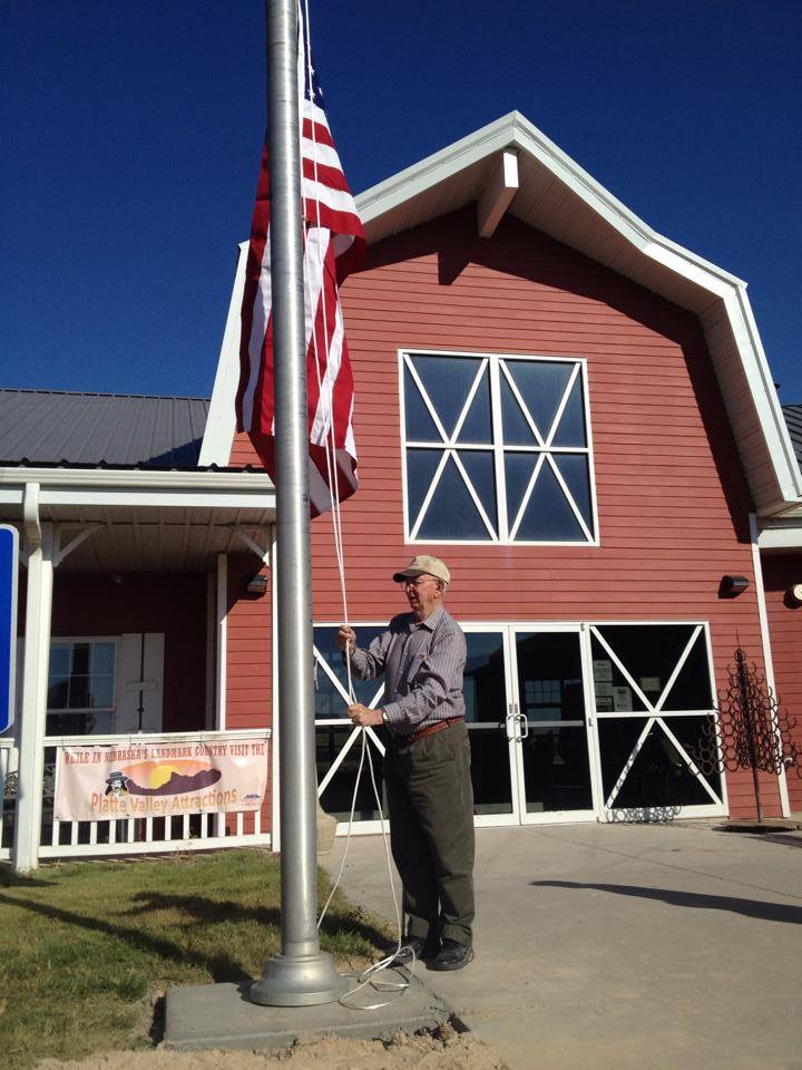 Charlie raising the flag on the new flagpole for the first time, 2014.